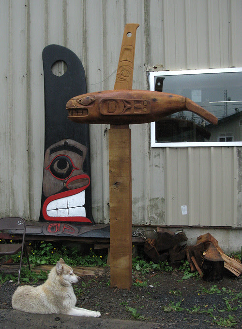 dog and carvings, Hydaburg, Alaska