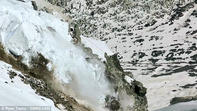 A large block of ice dislodges, smashes into a thousand pieces and plummets down the mountain