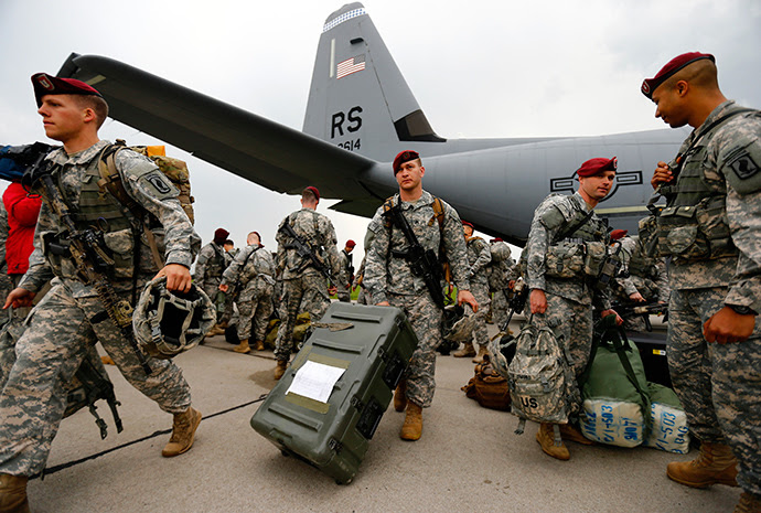 Soldiers from the first company-sized contingent of about 150 U.S. paratroopers from the U.S. Army's 173rd Infantry Brigade Combat Team based in Italy walk after unpacking as they arrive to participate in training exercises with the Polish army in Swidwin, northern west Poland April 23, 2014 (Reuters / Kacper Pempel)