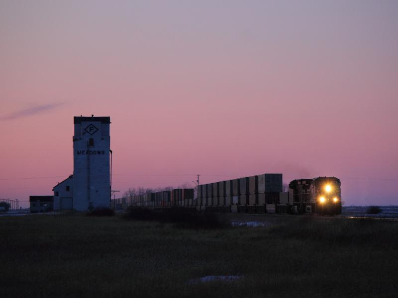 CEFX 1050 leads a train past the Meadows grain elevator