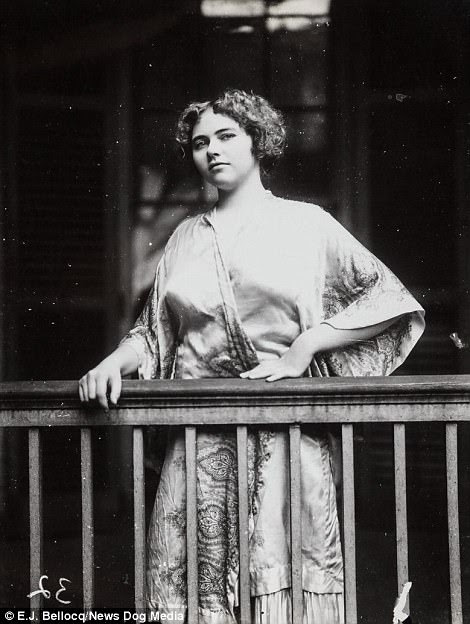 A woman on a balcony wearing a dressing gown in the area of Storyville, circa 1900s