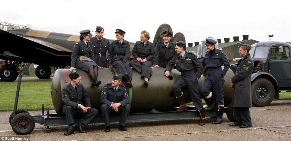 The crew relax and chat dressed in their wartime outfits at the airbase. The Bomber Command memorial will be unveiled in Green Park in June