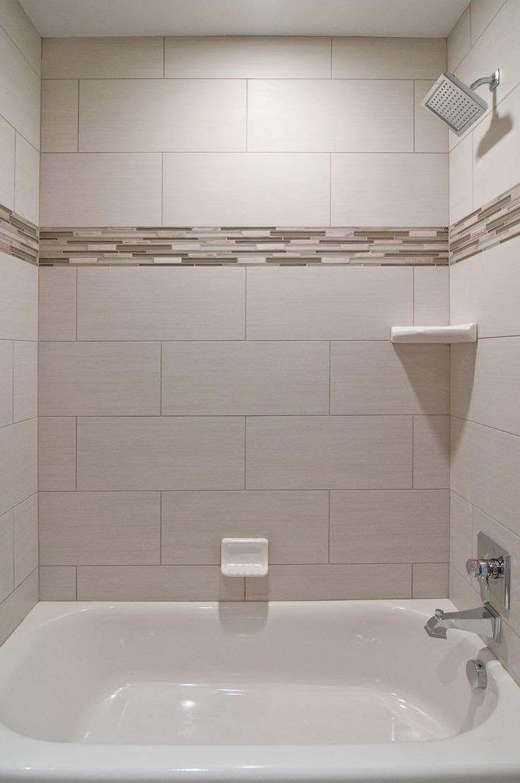 We love oversized subway tiles in this bathroom! The addition of glass accent tiles gives the space a custom look without being over the top. This is perfect for your secondary bathrooms. We also love the square showerhead from the #deltafaucet Dryden collection.