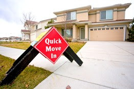 A 'Quick Move In' sign sits outside a home for sale in Denver in October. As banks begin to relax their down-payment requirements, some borrowers can now finance 95% instead of 90% of a property's value.