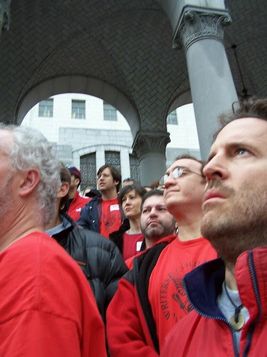 writers listen to speakers at City Hall