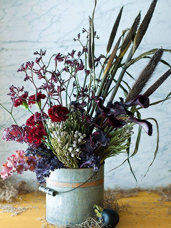 For an organic look straight out of nature, be a little eclectic in your fall display and arrangements. Gather a variety of flowers, stems, fillers, and twigs and arrange at random. Use a rustic or vintage-looking vessel, such as a galvanized bucket, to complete the look