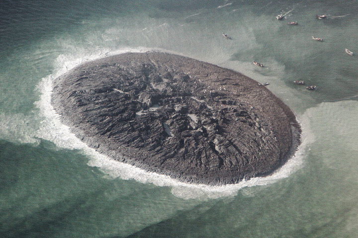 Close-up of the new island, estimated to stretch 75 to 90 meters (250 to 300 feet) across and standing 15 to 20 meters (60 to 70 feet) above the water line. The surface is a mixture of mud, fine sand, and solid rock.  Image via NASA Earth Observatory via National Institute of Oceanography.