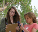 Photo of two students recording observations for Project BudBurst.