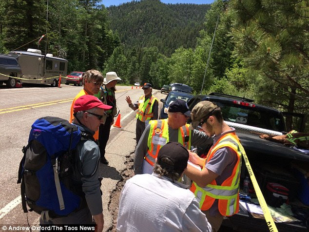 Concerns: Authorities said could have encountered trouble on the trail while trying to descend to the river to go fishing, but never suspected foul play. Pictured, search teams plot their course of action