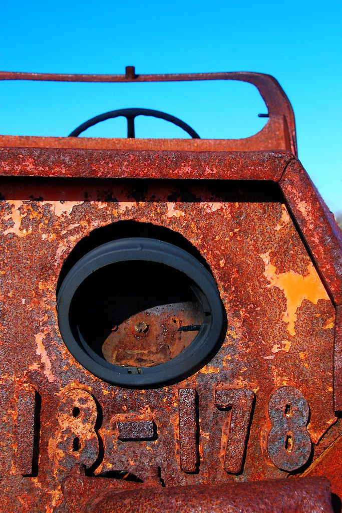 A rusty truck front, with the numbers 18-178 in metal.