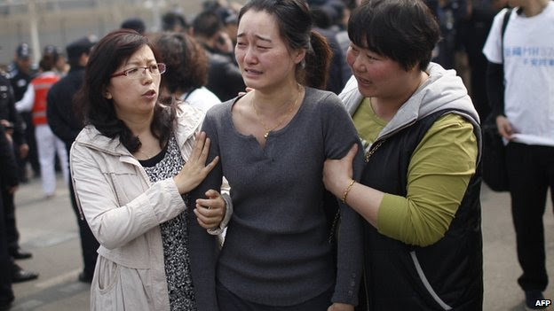 Grieving relative outside Malaysian embassy in Beijing. 24 March 2014