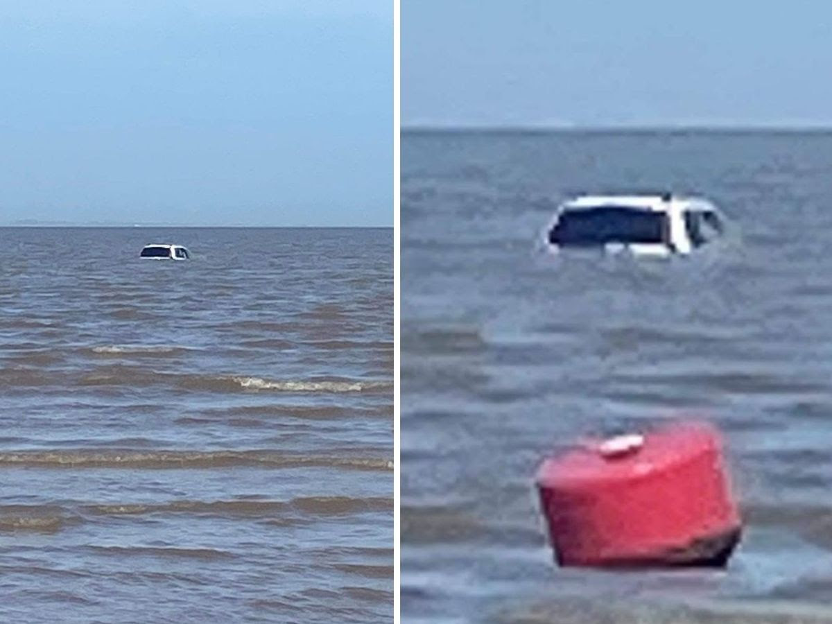 Stranded car submerged by sea on Cleethorpes beach