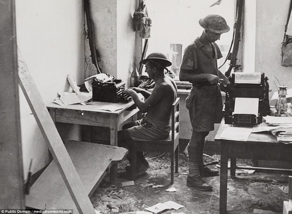 Pictured: The editor on the rotary machine seen with his assistant, who is typing. The powerful images show the desert campaign in great detail 