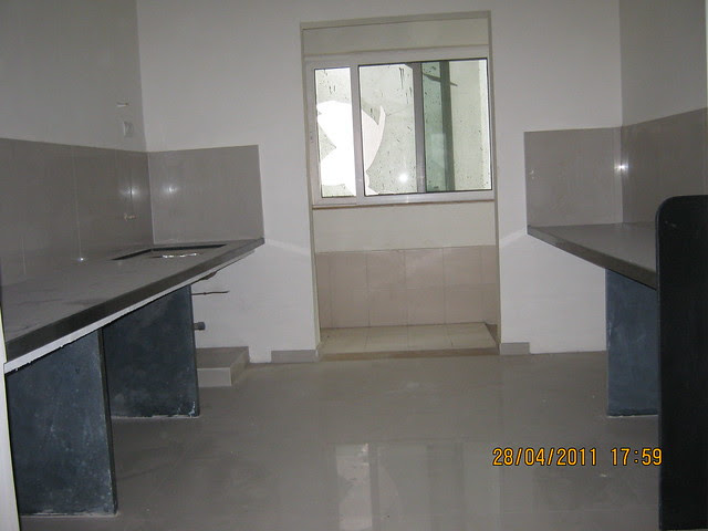Parallel Kitchen platform with jet black granite top and dry balcony in Sangria Towers at Megapolis Hinjewadi Phase 3, Pune