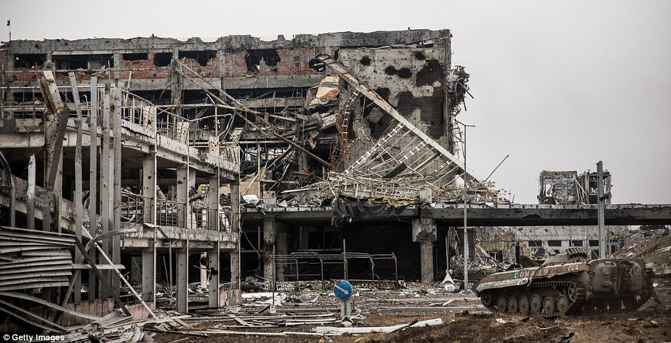 Crushed: A tank can be seen among the shattered buildings in the industrial city of Donetsk that was at the centre of the fighting
