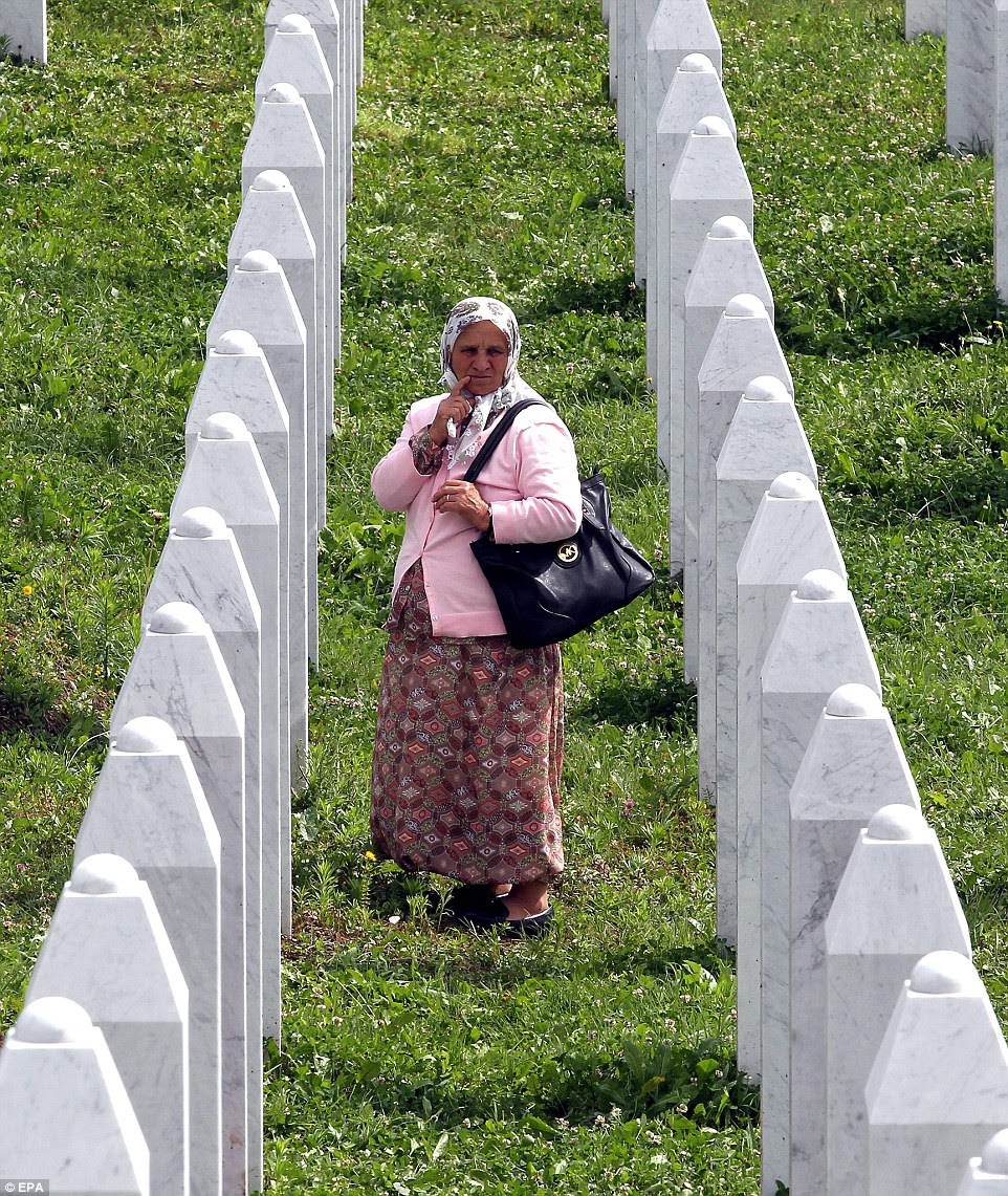 epa04310644 A contemplative Bosnian Muslim woman  at the Potocari Memorial Center during the funeral in Srebrenica, Bosnia and Herzegovina, 11 July 2014, where 175 newly-identified Bosnian Muslims were buried. The burial was part of a memorial ceremony to mark the 19th anniversary of the Srebrenica massacre, considered the worst atrocity of Bosnia's 1992-95 war. More than 8,000 Muslim men and boys were executed in the 1995 killing spree after Bosnian Serb forces overran the town.  EPA/FEHIIM DEMIR