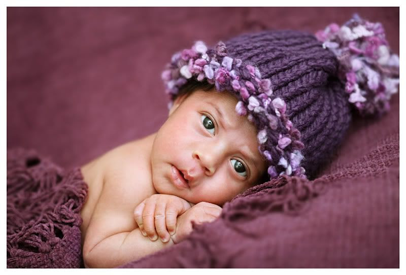 Baby photography, newborn portraits by Phil Lynch, Newborn baby photo in purple hat.