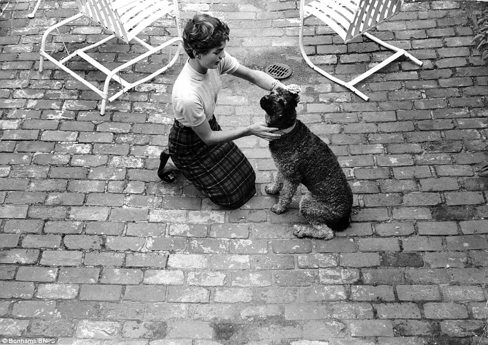 Jackie pictured with her french poodle, who she named after French President Charles de Gaulle. She named her pet De Gaulle — shortened to Gaullie