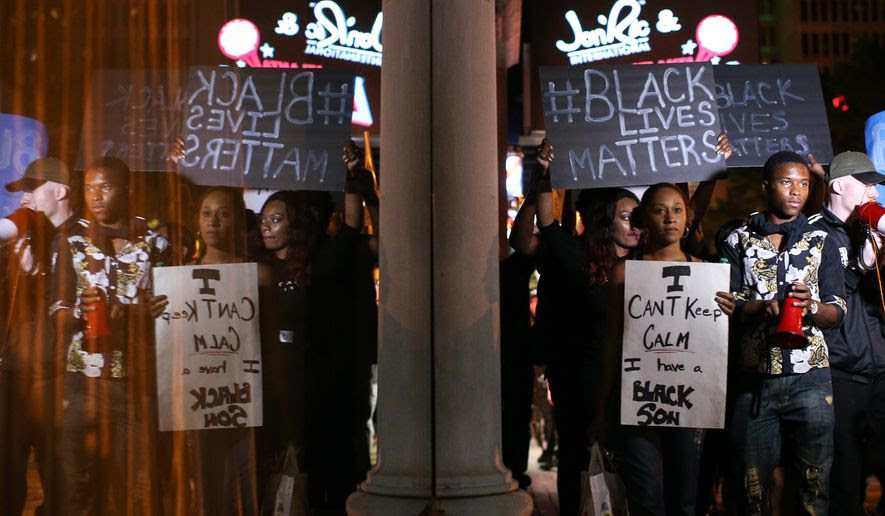 Black Lives Matter protesters march in downtown Atlanta, Saturday, Sept. 24, 2016, in response to the police shooting deaths of Terence Crutcher in Tulsa, Okla., and Keith Lamont Scott in Charlotte, N.C. (AP Photo/Branden Camp)