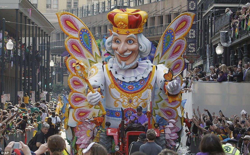 'Throw me somethin' mister!' The Rex Parade moves through New Orleans as hands wave in the air for beads and doubloons