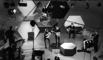 They're on the set of Q*Bert: The Motion Picture. A Hard Day's Night