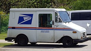 A small United States Postal Service truck see...