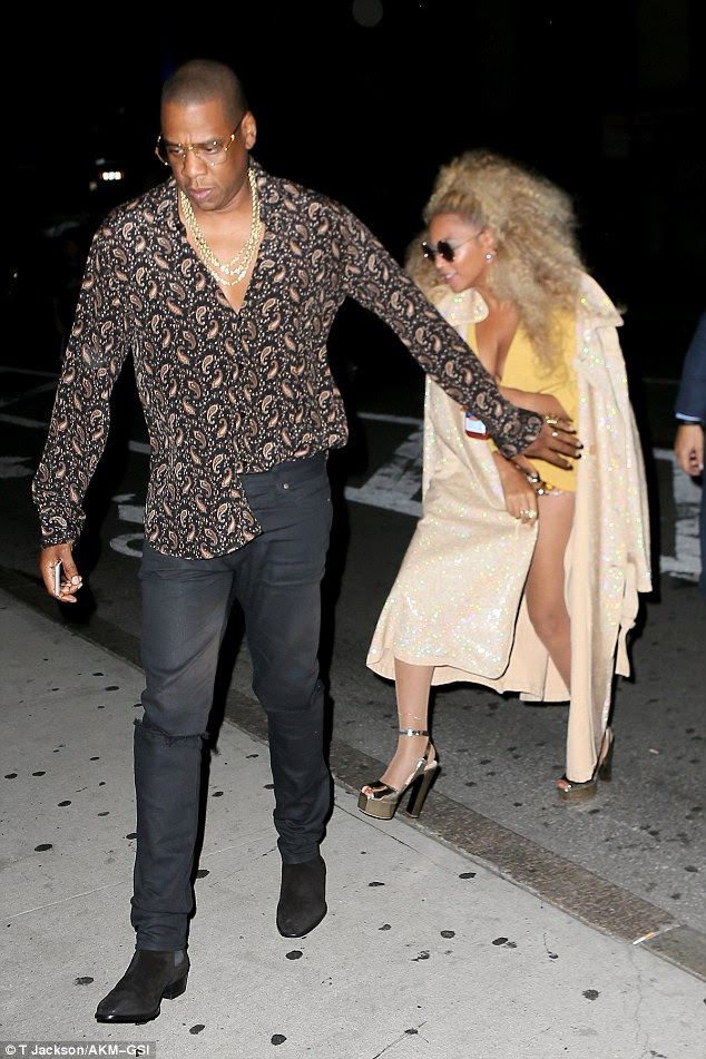 Nothing to see here! Jay-Z helped keep his wife's outfit a surprise as he strode past in a funky ensemble of his own which consisted of a paisley print shirt and thick gold chains