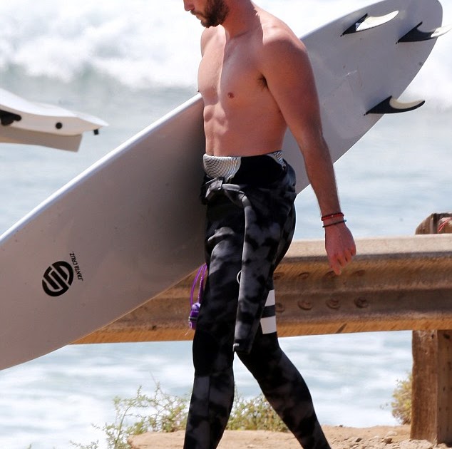 Liam Hemsworth Rocks a Wetsuit for Surfing at the Beach | Hollywood