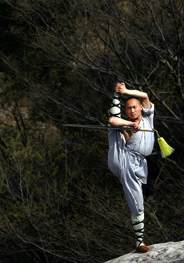DENGFENG, CHINA - APRIL 12: A warrior monk of the Shaolin Temple displays his Kung Fu skills at the Songshan Mountain near the temple April 12, 2005 in Dengfeng, Henan Province, China. Shaolin Temple, built in AD 495 in the period of the Northern and Southern Dynasties (420-581) and located in the Songshan Mountain area, is the birthplace of Shaolin Kung Fu. Shaolin Kung Fu, with its incredible strength, vitality and flexibility, is expecting to be included in the UNESCO intangible heritage list. (Photo by Cancan Chu/Getty Images)