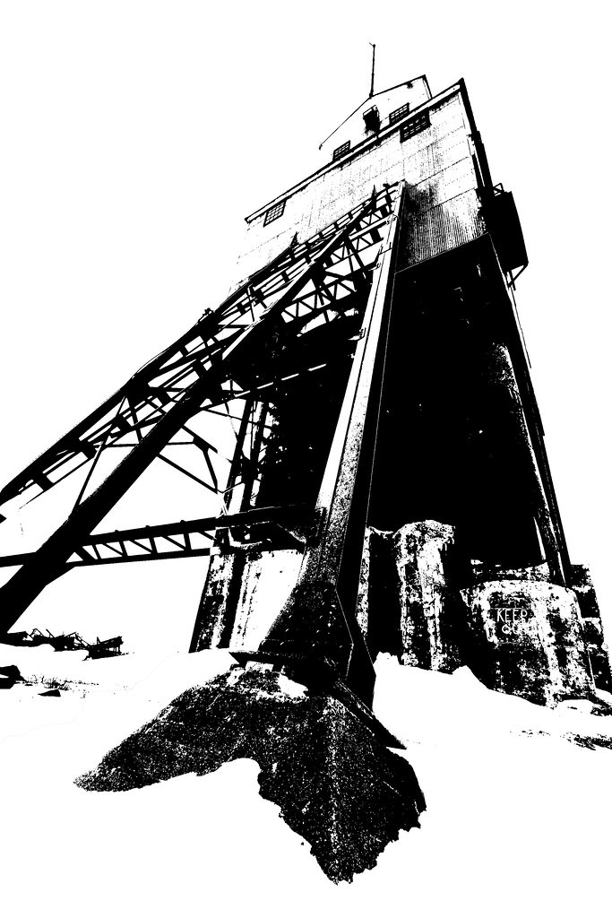 A black and white image of an abandoned mine building.