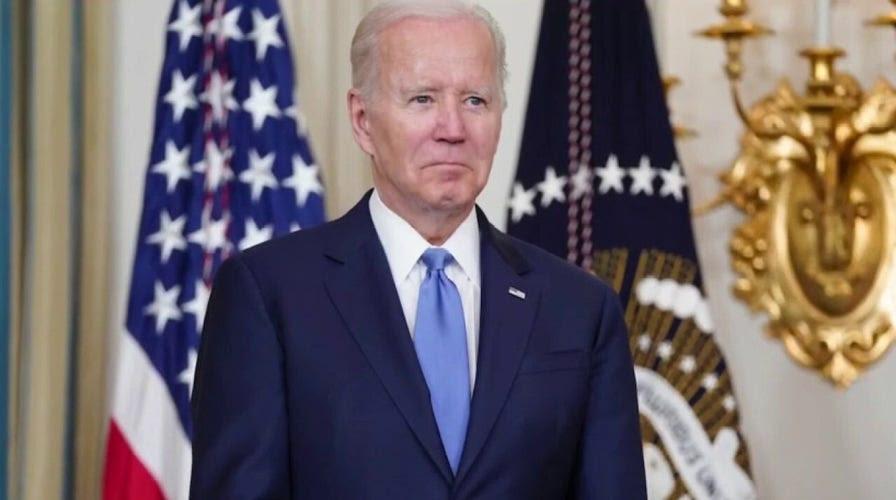 Biden holds notes that read 'YOU enter the Roosevelt Room,' 'YOU take YOUR seat'