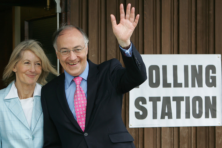 Former Conservative Party leader Michael Howard, now a legislator in Britain’s House of Lords, ran unsuccessfully against Labour’s Tony Blair in the 2005 U.K. general election. Pictured, Mr. Howard and his wife, Sandra, enter a polling station near Folkstone, England, May 5, 2005.