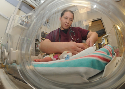 Navy medical officer examines baby durin by Official U.S. Navy Imagery, on Flickr