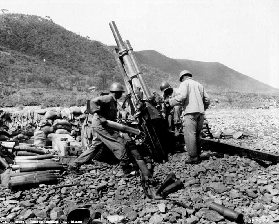 Men of Battery A, 159th Field Arillery Battalion, fire a 105-mm howitzer in an indirect firing mission on the Korean battle line, near Uirson on August 24, 1950. Often, bridges were targeted and destroyed in order to delay the advancement of North Korean troops