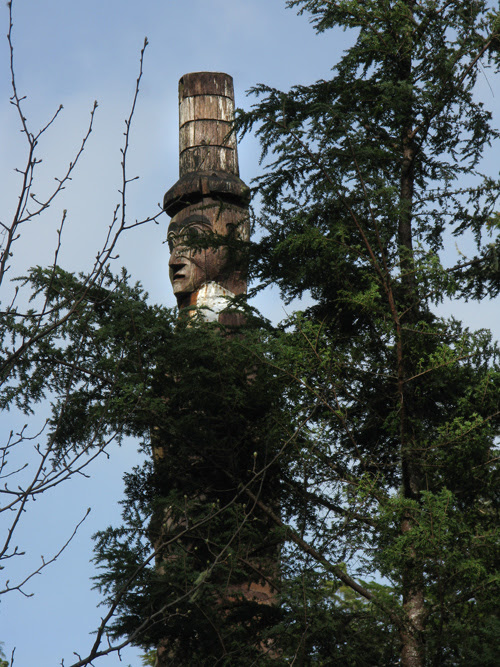 watchman figure seen through a tree, Kasaan, Alaska