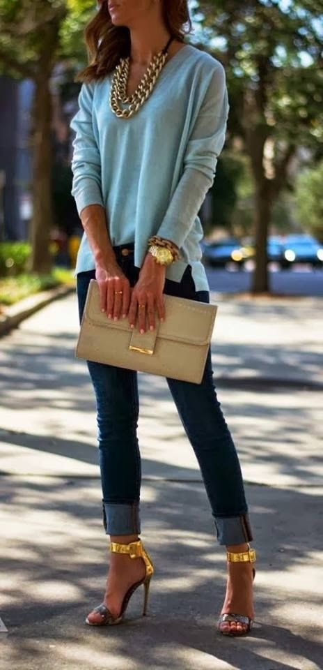 Adorable light blue blouse, golden necklace, jeans and high heels