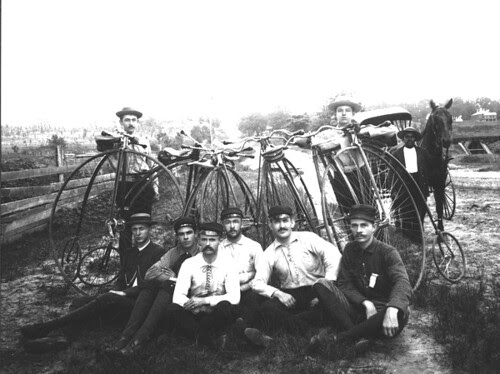 Eight young men with Penny-Farthing bicycles