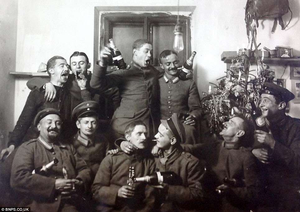 A rip-roaring good time: Members of the Imperial German Flying Corps can be seen swigging champagne and smoking cigars in Christmas 1917 during the First World War 