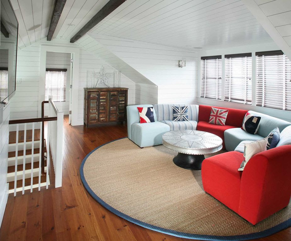 Contemporary Attic with High ceiling, Wall sconce, Hardwood floors, Exposed beam, Semi-circular sectional