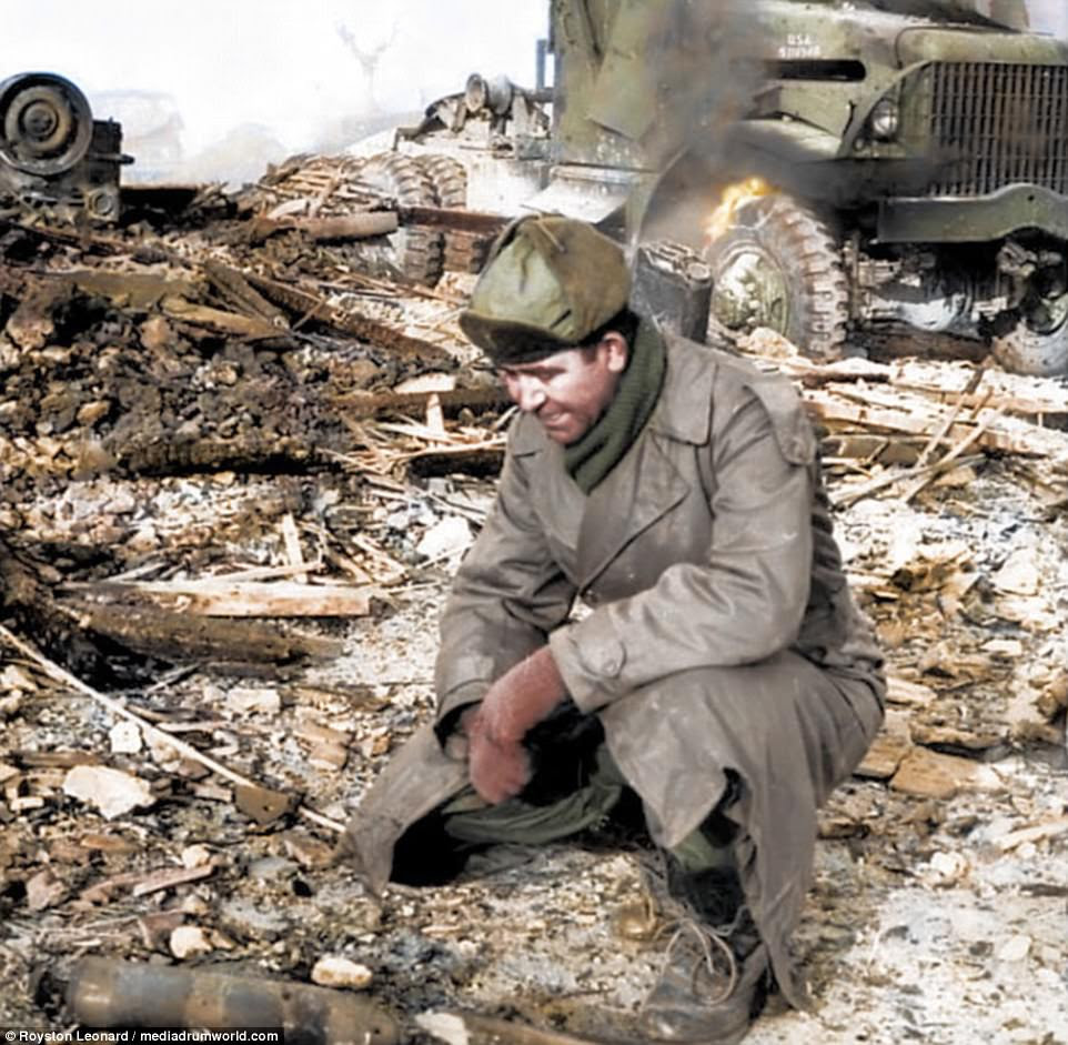 South Korea estimated that the number of civilian deaths in the three-year conflict topped 373,599, and said nearly 138,000 of its troops died in the war. Pictured above, a military member examines the damage in a region of Korea following a battle