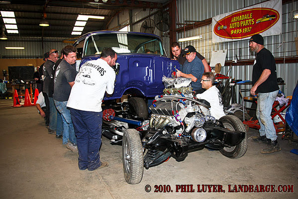 The team lifting the body onto the chassis while Blacky (right) gives valuable advise