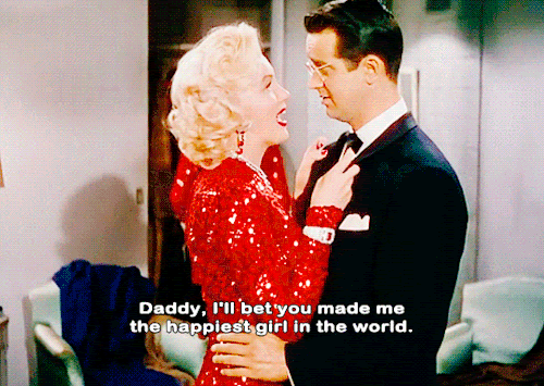 Marilyn's character, Lorelei, says 'Daddy, I'll bet you made me the happiest girl in the world' to her fiance and moves in for a kiss