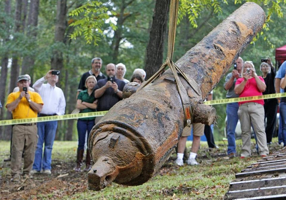 Onlookers take photos with their cell phones as a team of underwater archeologists, from the University of South Carolina, raise one of three Civil War cannons from the Great Pee Dee River near Florence, SC, Tuesday, September 29, 2015. Each cannon weighed upwards of 15,000 pounds.