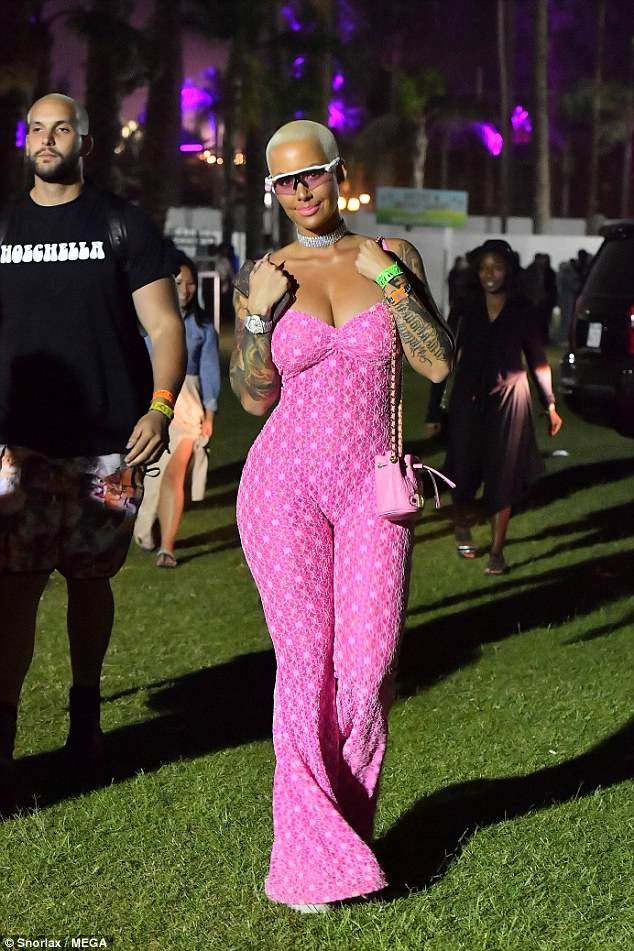 Eye popping:Â Amber Rose, 34, poured her sensational curves into a striking pink jumpsuit as she made a show-stopping arrival to Coachella on Friday