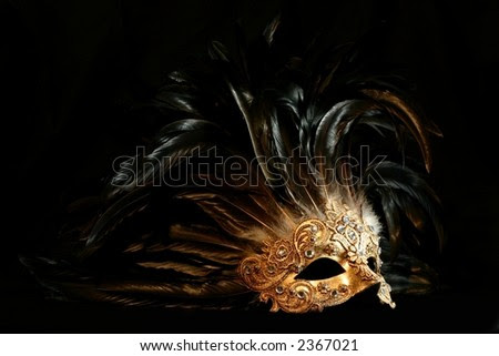 stock photo : A luxurious golden mask with long feathers on a black background stock photo : A luxurious golden mask with long feathers on a black background