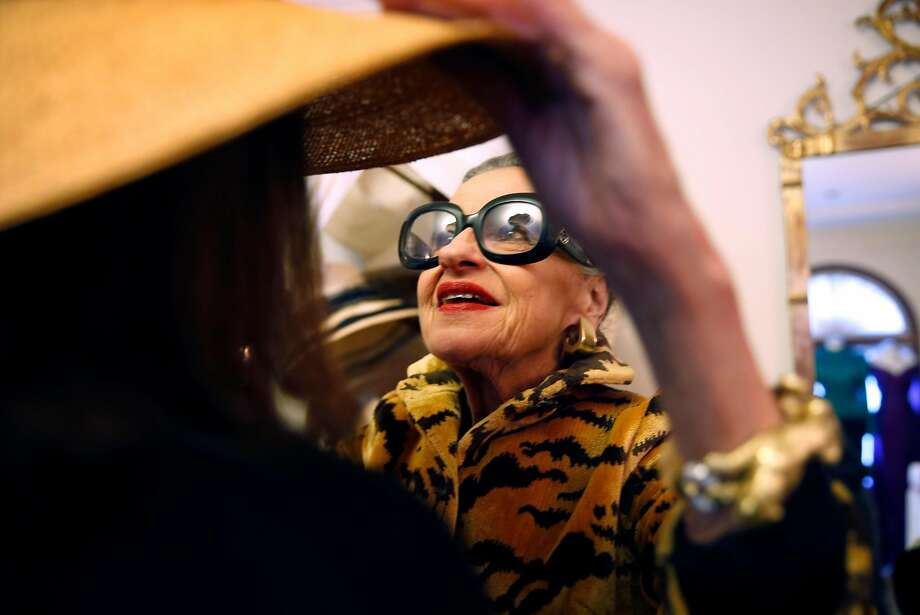 Joy Bianchi helps Allison Thompson try on a hat at Helpers House of Couture in San Francisco. Photo: Scott Strazzante, The Chronicle
