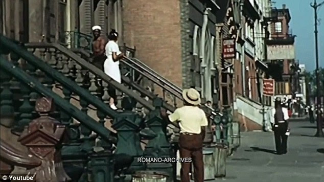 City life: Neighbors are seen chatting on the steps of a Harlem brownstone by cameraman Jean Vivier