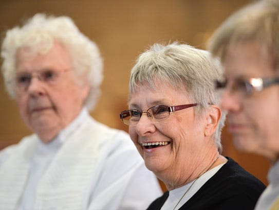 Rose Henzler, center, is studying to become a womanpriest.