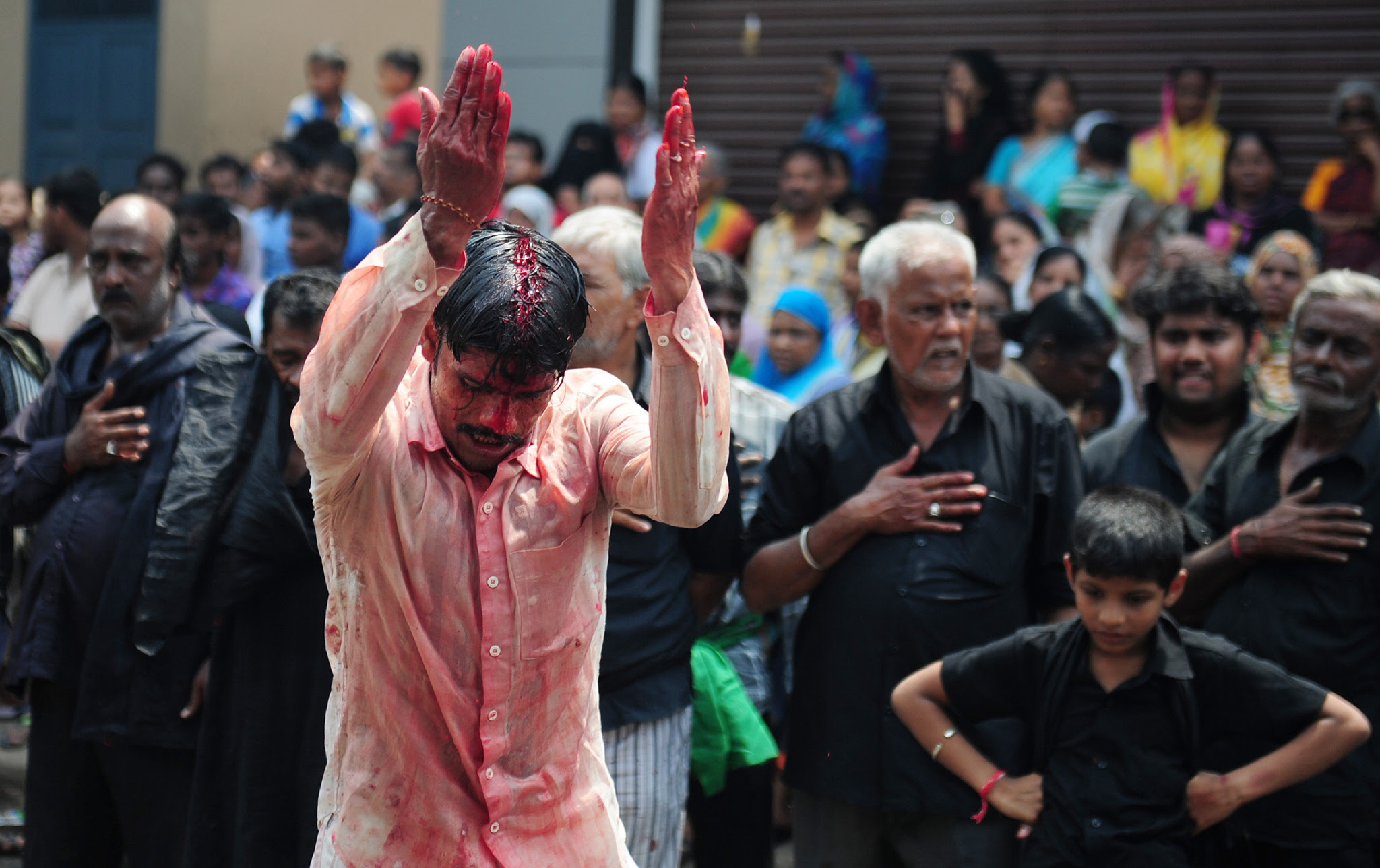 Indian Shia Muslim men flagellate themselves during the mourning procession on the tenth day of Muharram, which marks the day of Ashura, in Chennai on October 12, 2016. Ashura mourns the death of Imam Hussein, a grandson of the Prophet Mohammed, who was killed by armies of the Yazid near Karbala in 680 AD. / AFP PHOTO / ARUN SANKARARUN SANKAR/AFP/Getty Images