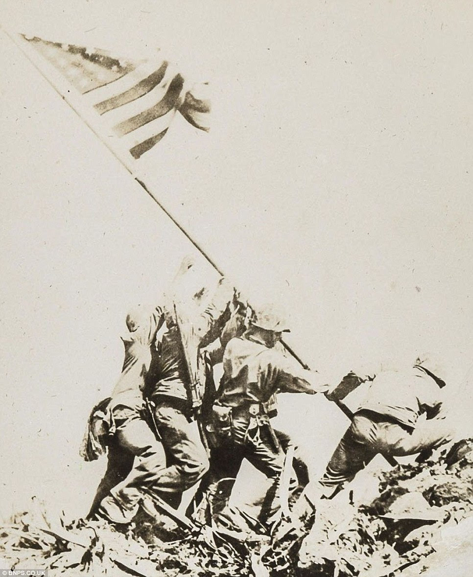 The moment the flag is raised in this original photo in Rosenthal's album